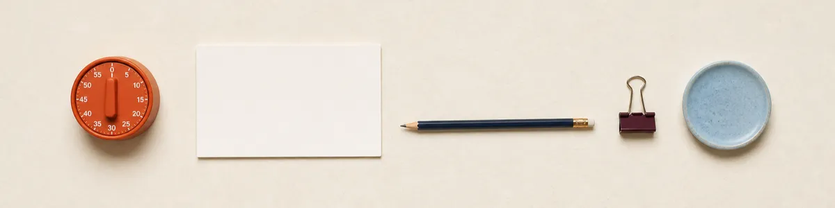 Blank activity card, analog timer, pencil, binder clip, and blue coaster arranged for one small between-session anxiety task