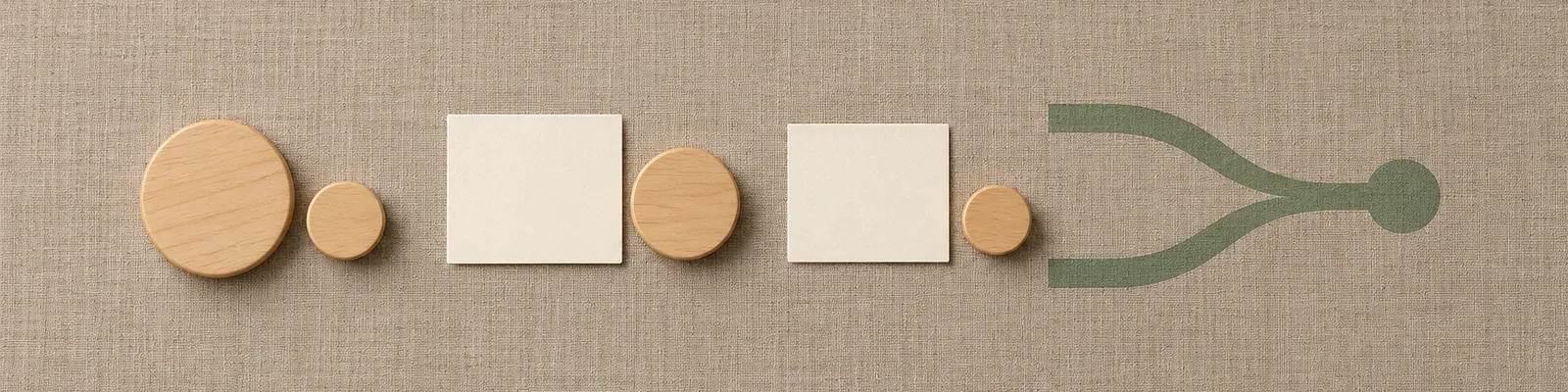 Paired large and small wooden caregiver and child tokens with blank response cards and one sage paired-path illustration on muted woven fabric.