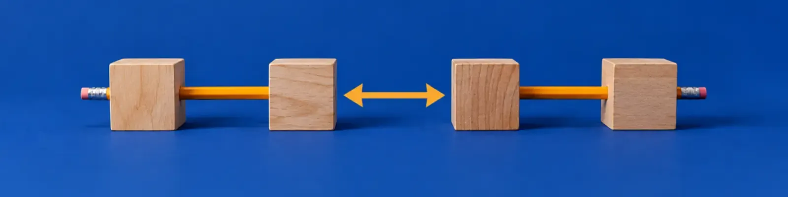 Two pairs of wooden conversation blocks facing across a marigold double arrow
