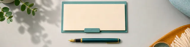 Top-down therapy desk with a blank teal consent folder, fountain pen, plant shadow, and chair fabric edge