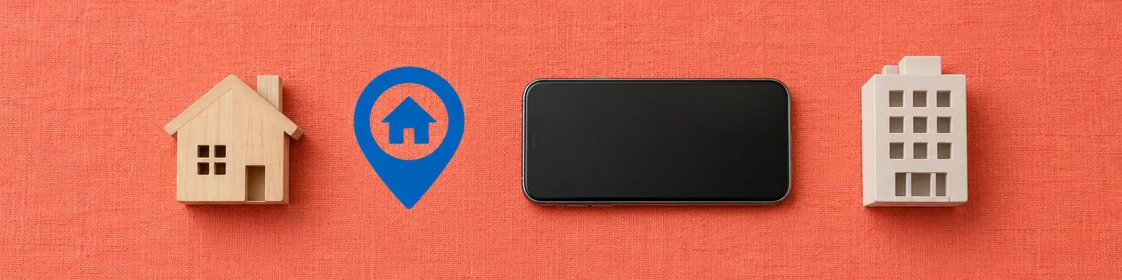 Wooden house, blank phone and office model beside one cobalt home-location icon on coral fabric.